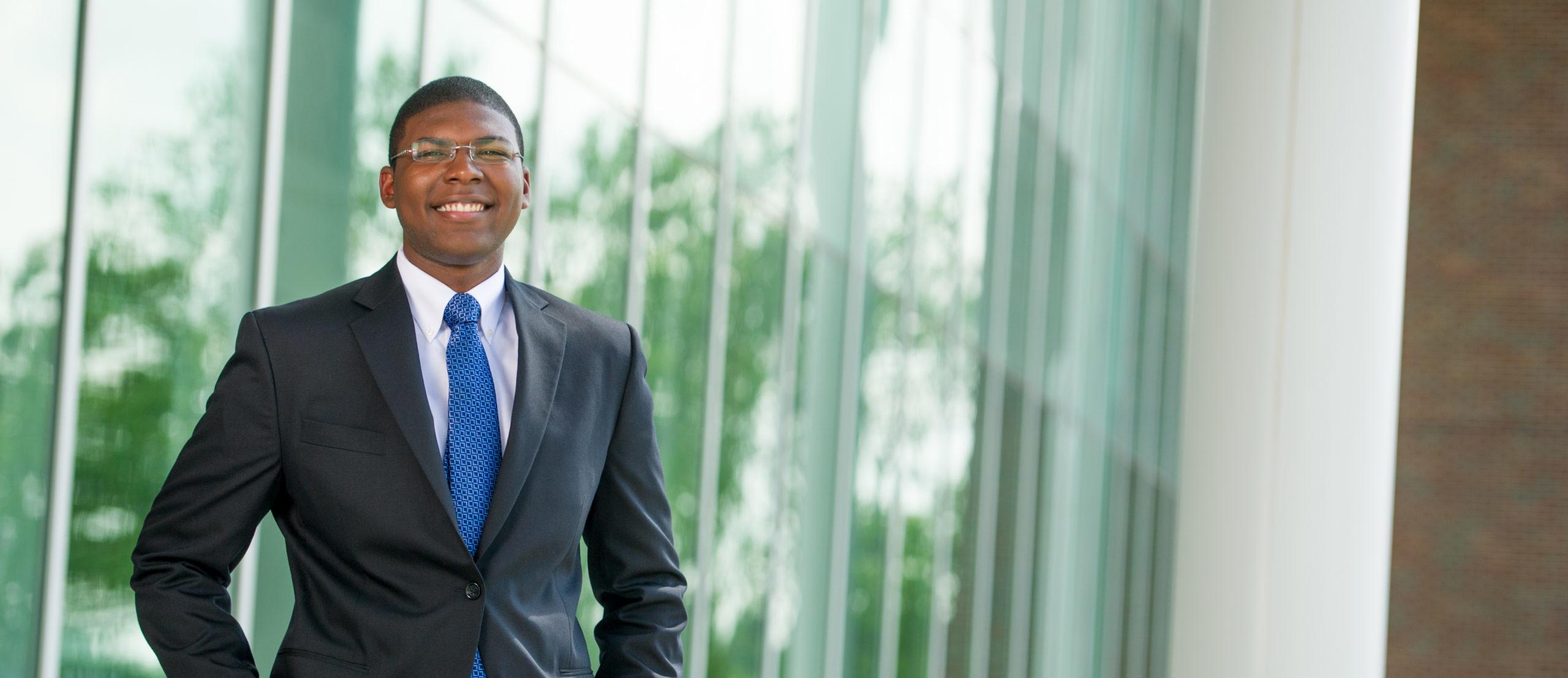 Man wearing professional attire with suit and blue tie